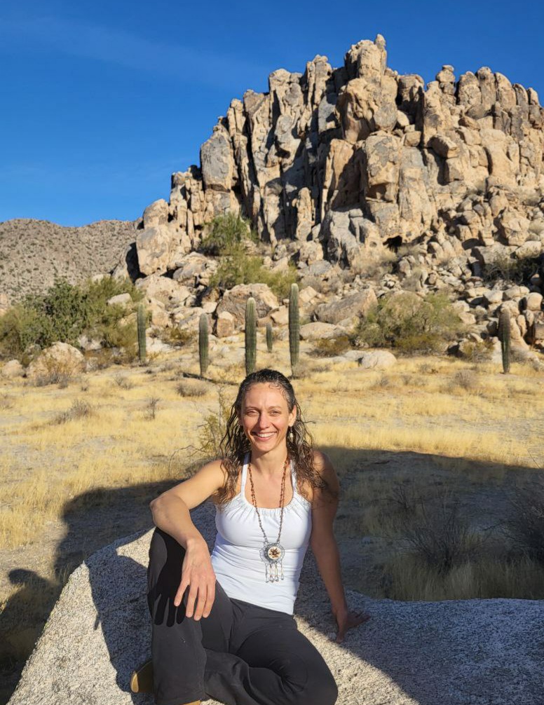 A person hiking through red rock desert terrain.